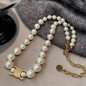 Affordable jewelry NYC pearl necklace with gold clasp and designer-inspired charm