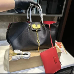 Black leather designer handbag with gold chain accent and red pouch, Handbags Brooklyn NY