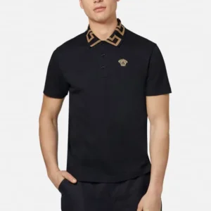 Man in black polo with gold collar detail, studio shot