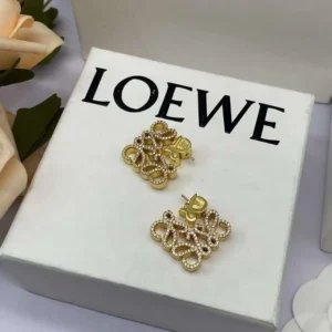 Gold crystal knot stud earrings on LOVE box display, Fashion jewelry NYC